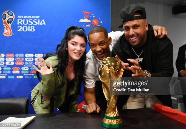 Era Istrefi, Will Smith and Nicky Jam pose with the World Cup trophy at a closing ceremony press conference during the 2018 FIFA World Cup at...