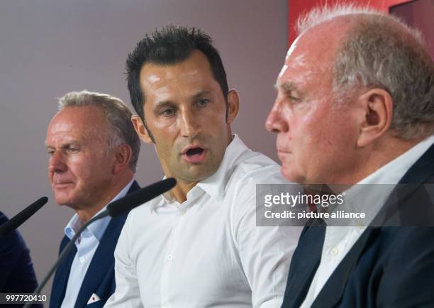 Hasan Salihamidzic sitting between FC Bayern Munich President, Uli Hoeness , and FC Bayern Munich's Chairman, Karl-Heinz Rummenigge , during his...