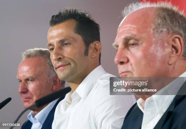 Hasan Salihamidzic sitting between FC Bayern Munich President, Uli Hoeness , and FC Bayern Munich's Chairman, Karl-Heinz Rummenigge , during his...