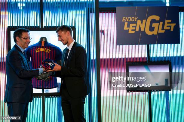 Barcelona's new player French defender Clement Lenglet poses with Barcelona's president Josep Maria Bartomeu during his official presentation at the...