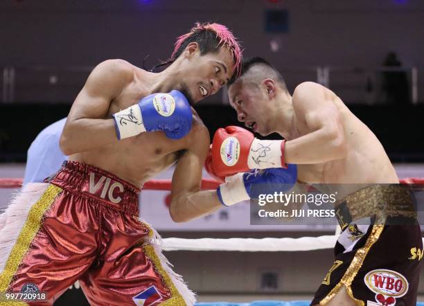 Japan's Ryuya Yamanaka and Vic Saludar of the Philippines fight during their WBO minimumweight title boxing bout in Kobe, Hyogo prefecture on July...