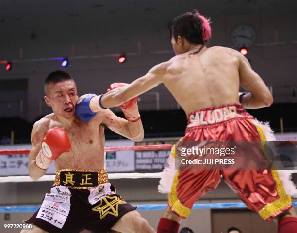 Japan's Ryuya Yamanaka and Vic Saludar of the Philippines fight during their WBO minimumweight title boxing bout in Kobe, Hyogo prefecture on July...
