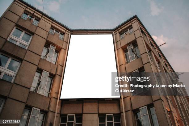 blank billboard on building facade - building billboard stock pictures, royalty-free photos & images