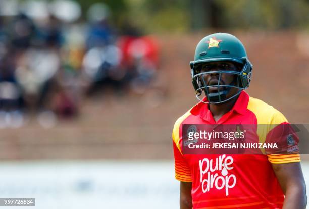 Zimbabwe's captain Hamilton Masakadza walks back to the pavilion after his dismissal during the first one day international cricket match between...