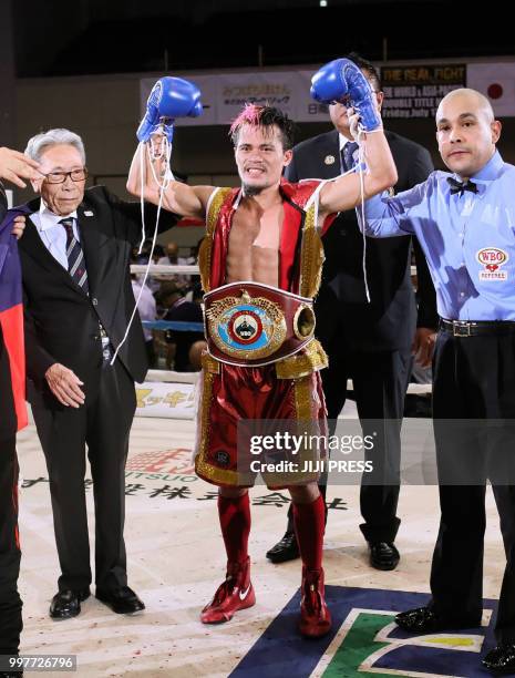 Vic Saludar of the Philippines celebrates his win over Japan's Ryuya Yamanaka after their WBO minimumweight title boxing bout in Kobe, Hyogo...