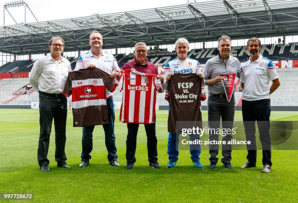 St. Pauli's technical director Ewald Lienen, Stoke City's technical director Mark Cartwright, St. Pauli's manager Olaf Janßen, Stoke's manager Mark...