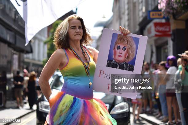 Demonstrator with an anti Trump placard saying "President Evil" attends the Drag Protest Parade LGBTQi March against Trump on July 13, 2018 in...