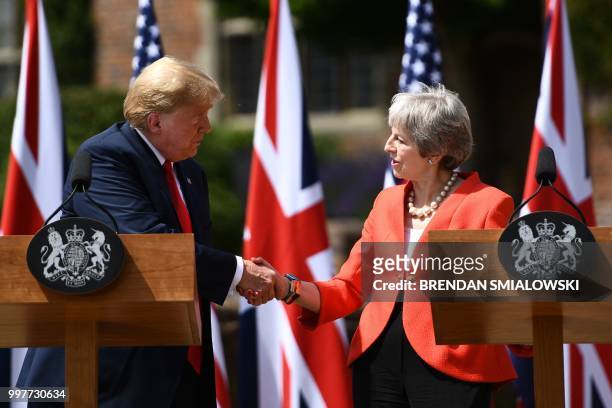President Donald Trump and Britain's Prime Minister Theresa May shake hands at a press conference following their meeting at Chequers, the prime...