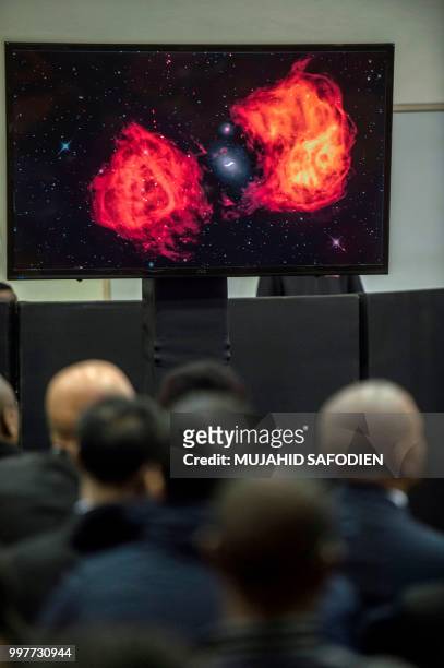 Space images are shown to members of the media and delegates during the official unveiling ceremony of a 64-dish radio telescope system, on July 13,...