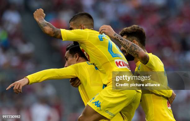 Napoli's Jose Callejon celebrates with Lorenzo Insigne and Alessio Zerbin his scoring the opening goal during the Audi Cup semi-final match pitting...