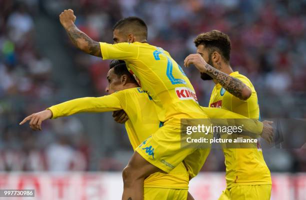 Napoli's Jose Callejon celebrates with Lorenzo Insigne and Alessio Zerbin his scoring the opening goal during the Audi Cup semi-final match pitting...