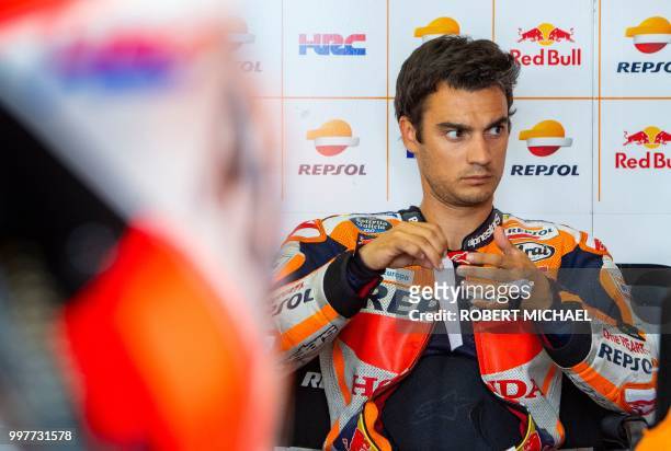 Spanish Honda rider Dani Pedrosa prepares in the box prior to the second training session of the Moto GP for the Grand Prix of Germany at the...