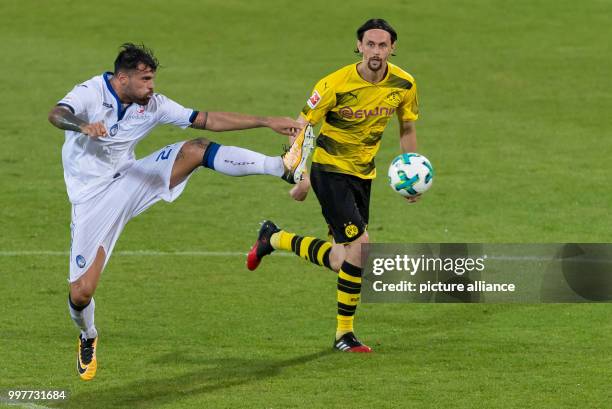 Bergamo's Andrea Petagna and Dortmund's Neven Subotic vie for the ball during the Borussia Dortmund vs Atalanta Bergamo test match in Altach,...