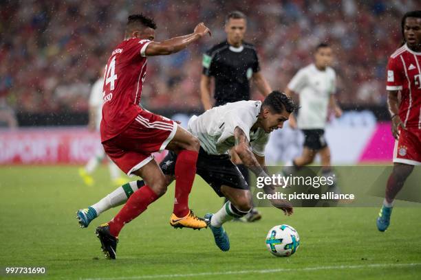Bayern Munich's Corentin Tolisso and Liverpool's Roberto Firmino vie for the ball during the Audi Cup semi-final pitting FC Bayern Munich vs FC...