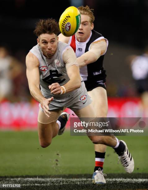 Dale Thomas of the Blues handpasses the ball ahead of Ed Phillips of the Saints during the 2018 AFL round 17 match between the St Kilda Saints and...