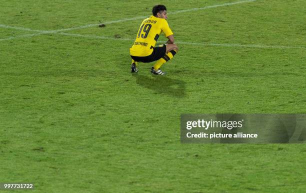 Dortmund's Mahmoud Dahoud squats disappointed on the pitch after the Borussia Dortmund vs Atalanta Bergamo test match in Altach, Austria, 01 August...