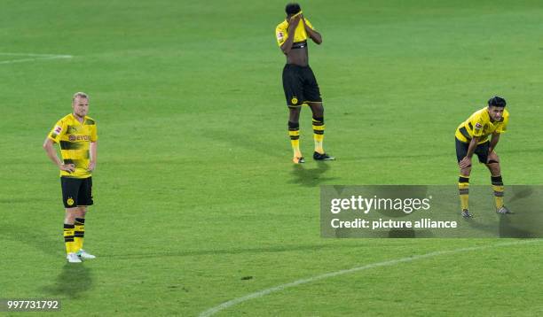 Dortmund's Mahmoud Dahoud, Dan-Axel Zagadou and Sebastian Rode stand disappointed on the pitch after the Borussia Dortmund vs Atalanta Bergamo test...