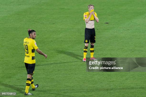 Dortmund's Jan-Niklas Beste and Mahmoud Dahoud stand disappointed on the pitch after the Borussia Dortmund vs Atalanta Bergamo test match in Altach,...