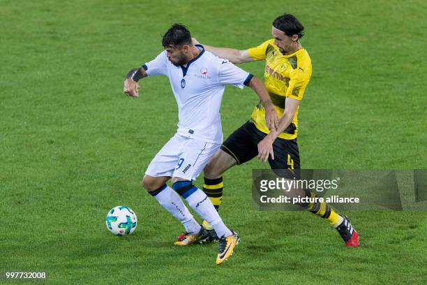 Dortmund's Neven Subotic and Bergamo's Andrea Petagna vie for the ball during the Borussia Dortmund vs Atalanta Bergamo test match in Altach,...