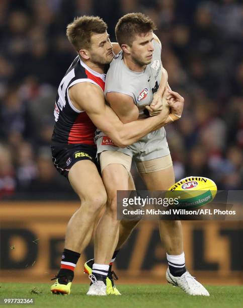 Marc Murphy of the Blues is tackled by Maverick Weller of the Saints during the 2018 AFL round 17 match between the St Kilda Saints and the Carlton...