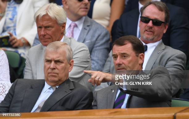 Britain's Prince Andrew, Duke of York sits in the Royal box on Centre Court to watch US player John Isner play South Africa's Kevin Anderson during...