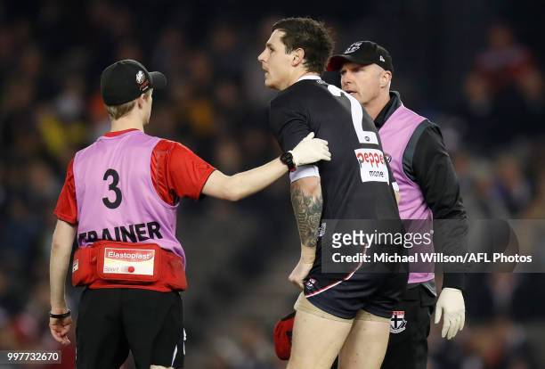 Jake Carlisle of the Saints is treated by trainers during the 2018 AFL round 17 match between the St Kilda Saints and the Carlton Blues at Etihad...