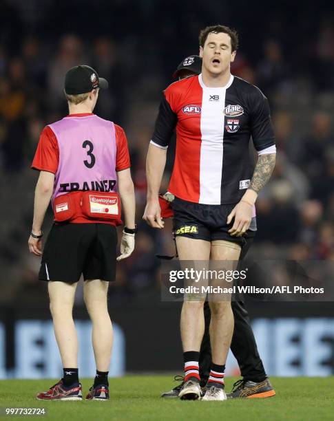 Jake Carlisle of the Saints is treated by trainers during the 2018 AFL round 17 match between the St Kilda Saints and the Carlton Blues at Etihad...