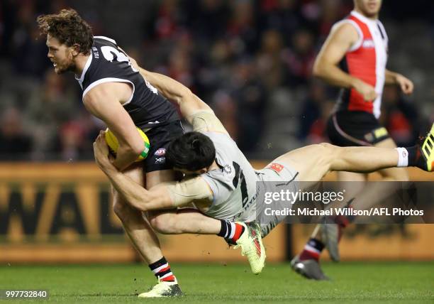 Jack Steven of the Saints is tackled by Matthew Kennedy of the Blues during the 2018 AFL round 17 match between the St Kilda Saints and the Carlton...