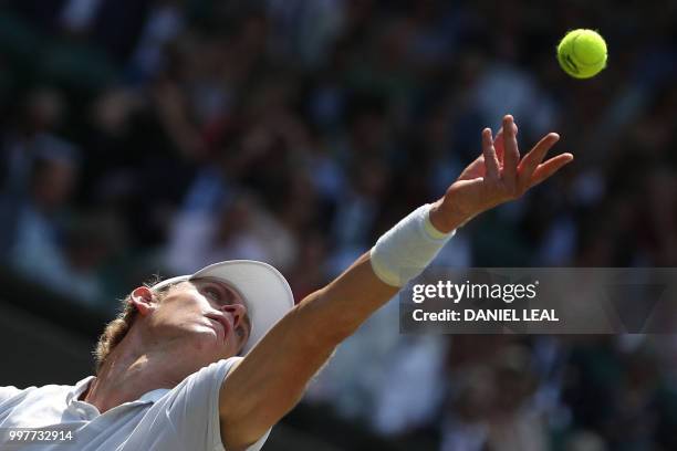 South Africa's Kevin Anderson throws the ball to serve against US player John Isner during their men's singles semi-final match on the eleventh day...