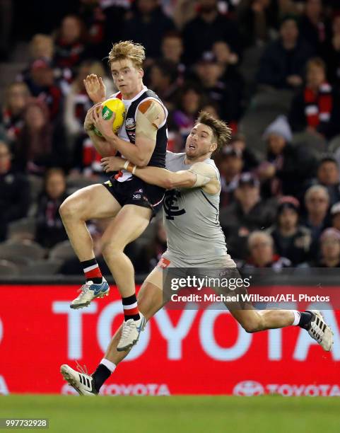 Ed Phillips of the Saints and Dale Thomas of the Blues compete for the ballduring the 2018 AFL round 17 match between the St Kilda Saints and the...