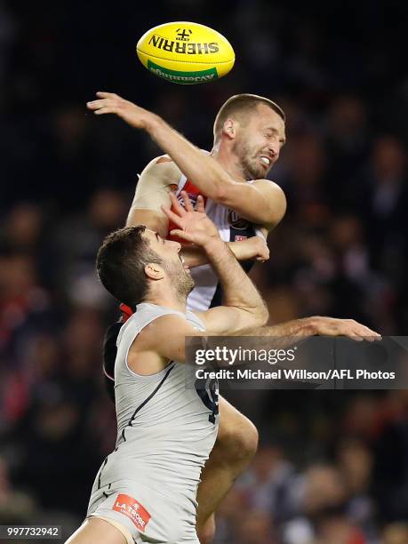 Kade Simpson of the Blues is taken high by Jarryn Geary of the Saints during the 2018 AFL round 17 match between the St Kilda Saints and the Carlton...