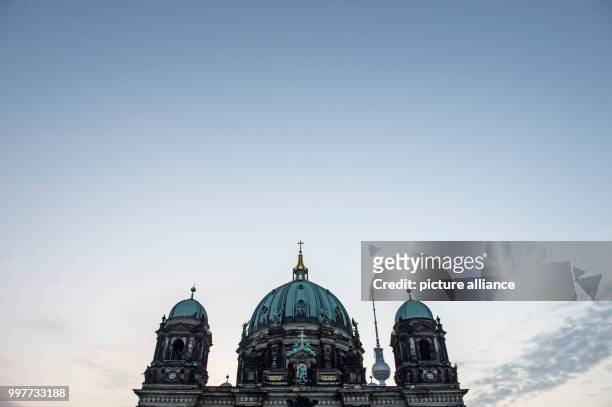 Dpatop - The spires of the Berlin Cathedral and the tip of the Television Tower rise into the morning sky in Berlin, Germany, 02 August 2017. Photo:...