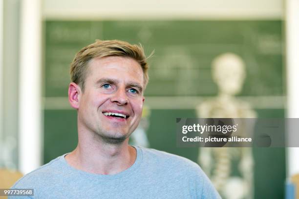 Former professional soccer player Tobias Rau pictured in a classroom of a comprehensive school in Borgholzhausen, Germany, 17 May 2017. The former...