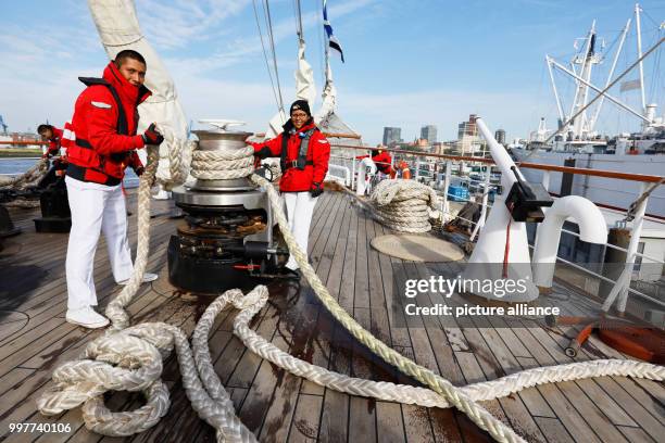 Third sergeant and helmsman, Justo Jack Vasquez and crewmember Alicia Pacacios Rojas tie a mooring line on the Peruvian school ship "Union" in the...