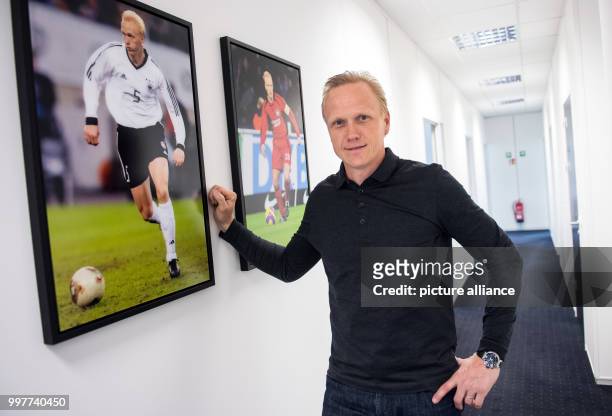 Picture of former professional soccer player and currently businessman Carsten Ramelow taken in a corridor in front of his office next to pictures...