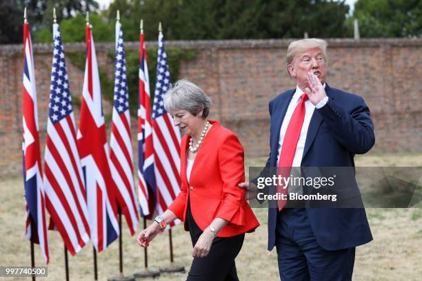 President Donald Trump, speaks to the media as he holds onto Theresa May, U.K. Prime minister, following their joint news conference at Chequers in...