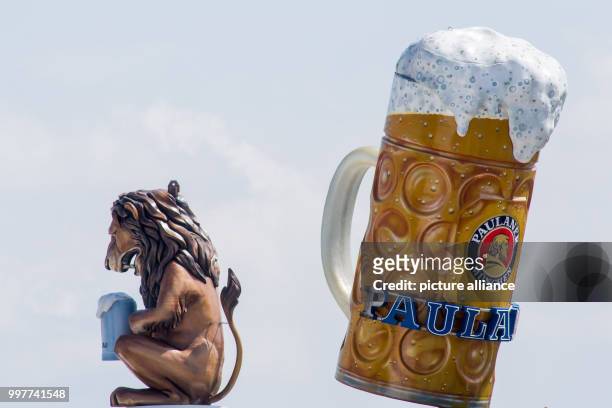Lion figure and a gigantic beer glass are being visible in the sky in Munich, Germany, 2 August 2017. The Oktoberfest takes place between 16...