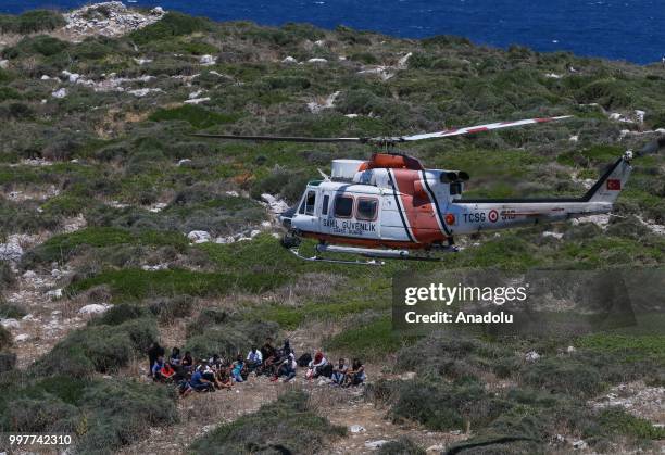 Helicopter arrives within an operation launched by Turkish Coast Guard Command to save around 34 irregular migrants stranded on an island off the...