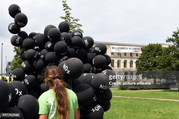 Greenpeace activist protests in front of the Ministry of Transport after a summit on the reduction of diesel use on August 2, 2017 in Berlin. The...