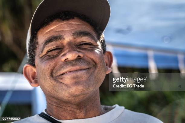 portrait of brazilian mature men at the beach - pernambuco state stock pictures, royalty-free photos & images