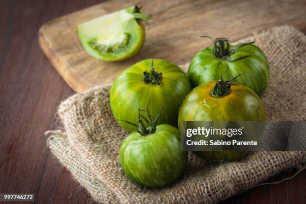 fresh raw green tomatoes - beefsteak tomato stock pictures, royalty-free photos & images