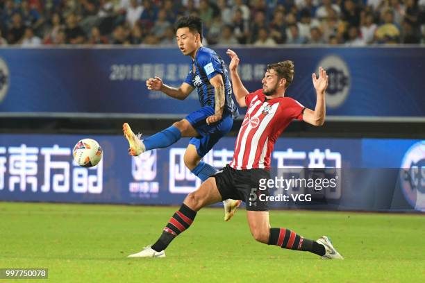 Zhang Lingfeng of Jiangsu Suning and Jack Stephens of Southampton compete for the ball during the 2018 Clubs Super Cup match between Southampton FC...