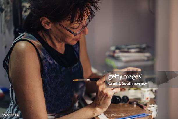 woman making jewelry in a store - jasper mineral stock pictures, royalty-free photos & images