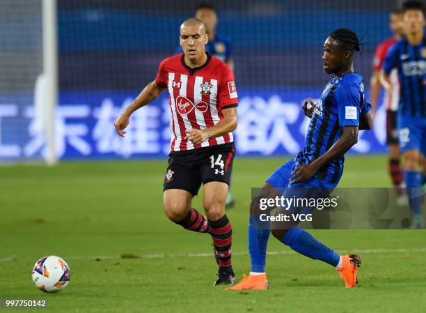 Richmond Boakye of Jiangsu Suning and Oriol Romeu of Southampton compete for the ball during the 2018 Clubs Super Cup match between Southampton FC...
