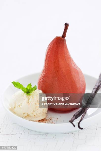 homemade poached pear with vanilla ice cream, mint and vanilla sticks, closeup - mint ice cream stock pictures, royalty-free photos & images