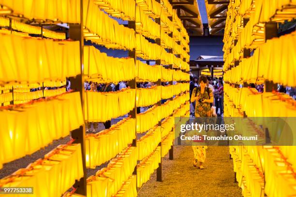 Woman takes a photograph of her daughter during the Mitama Matsuri summer festival at the Yasukuni Shrine on July 13, 2018 in Tokyo, Japan. The...