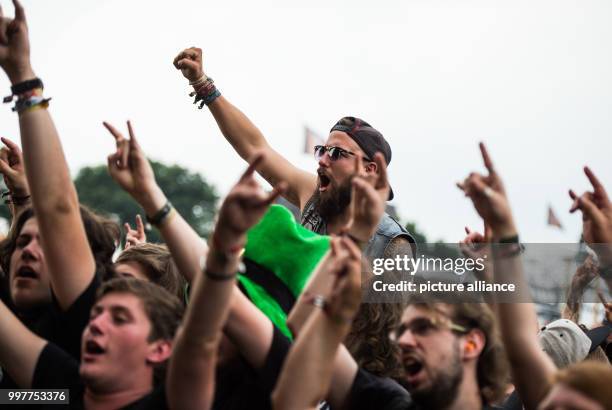 During a Wacken Firefighters concert, fans make the sign of the horns with their hands, synonomous with heavy metal on the grounds of Wacken Festival...