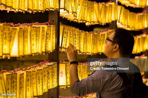 Man looks at lit paper lanterns during the Mitama Matsuri summer festival at the Yasukuni Shrine on July 13, 2018 in Tokyo, Japan. The four-day...