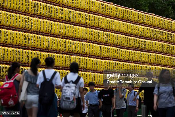 People walk past lit paper lanterns during the Mitama Matsuri summer festival at the Yasukuni Shrine on July 13, 2018 in Tokyo, Japan. The four-day...