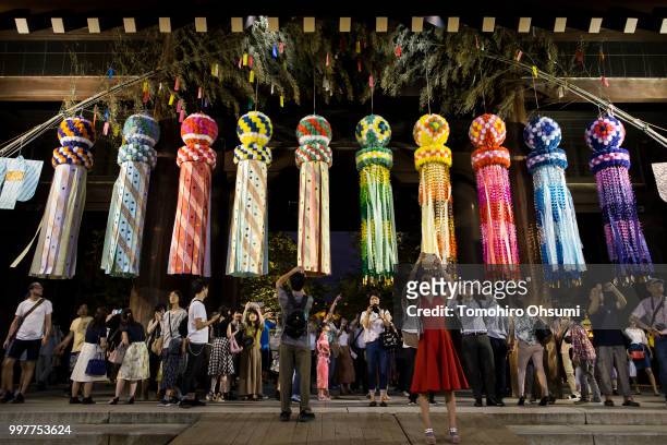 People take photographs of lit paper lanterns during the Mitama Matsuri summer festival at the Yasukuni Shrine on July 13, 2018 in Tokyo, Japan. The...